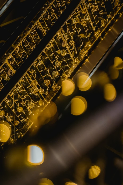 a clock that is on the side of a building, an album cover, by Jacob Toorenvliet, trending on unsplash, lyrical abstraction, glowing gold embers, musical organ, high angle close up shot, lights on ceiling