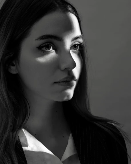 a black and white photo of a woman with long hair, inspired by Elsa Bleda, unsplash contest winner, photorealism, chloe bennet, dramatic lighting shadows, portrait of lady gaga, girl in suit