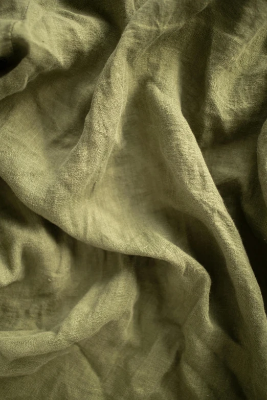 a close up of a blanket on a bed, a picture, inspired by Art Green, unsplash, renaissance, dirty green clothes, flax, slight yellow hue, transparent cloth