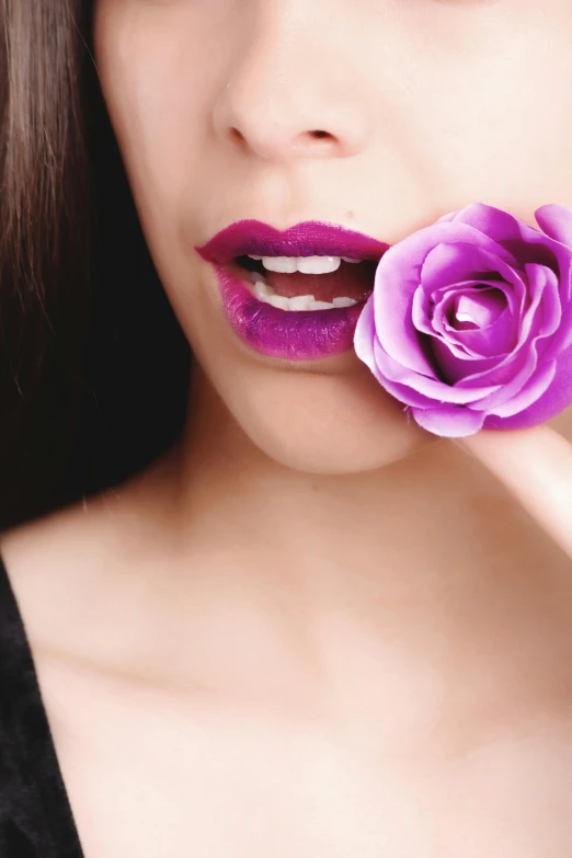 a woman with a purple rose in her mouth, inspired by Bert Stern, trending on pexels, romanticism, cosmetics, vampire teeth, holding magic flowers, sexy lips :5 stylish