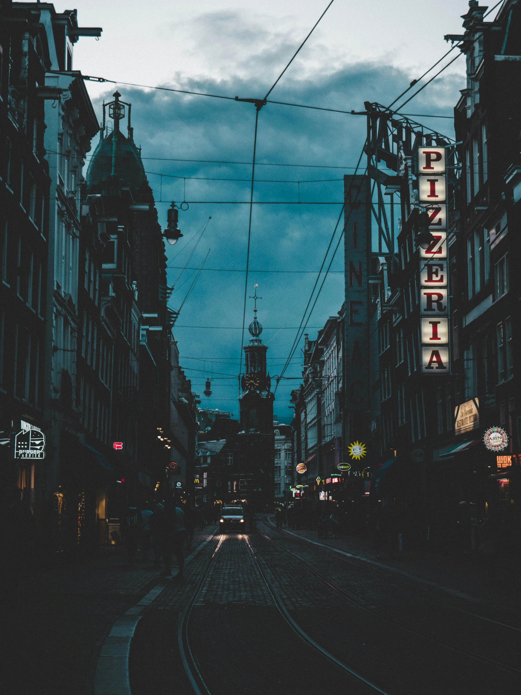 a city street filled with lots of tall buildings, an album cover, pexels contest winner, viennese actionism, dark and dim lighting, dark university aesthetic, street signs, amsterdam