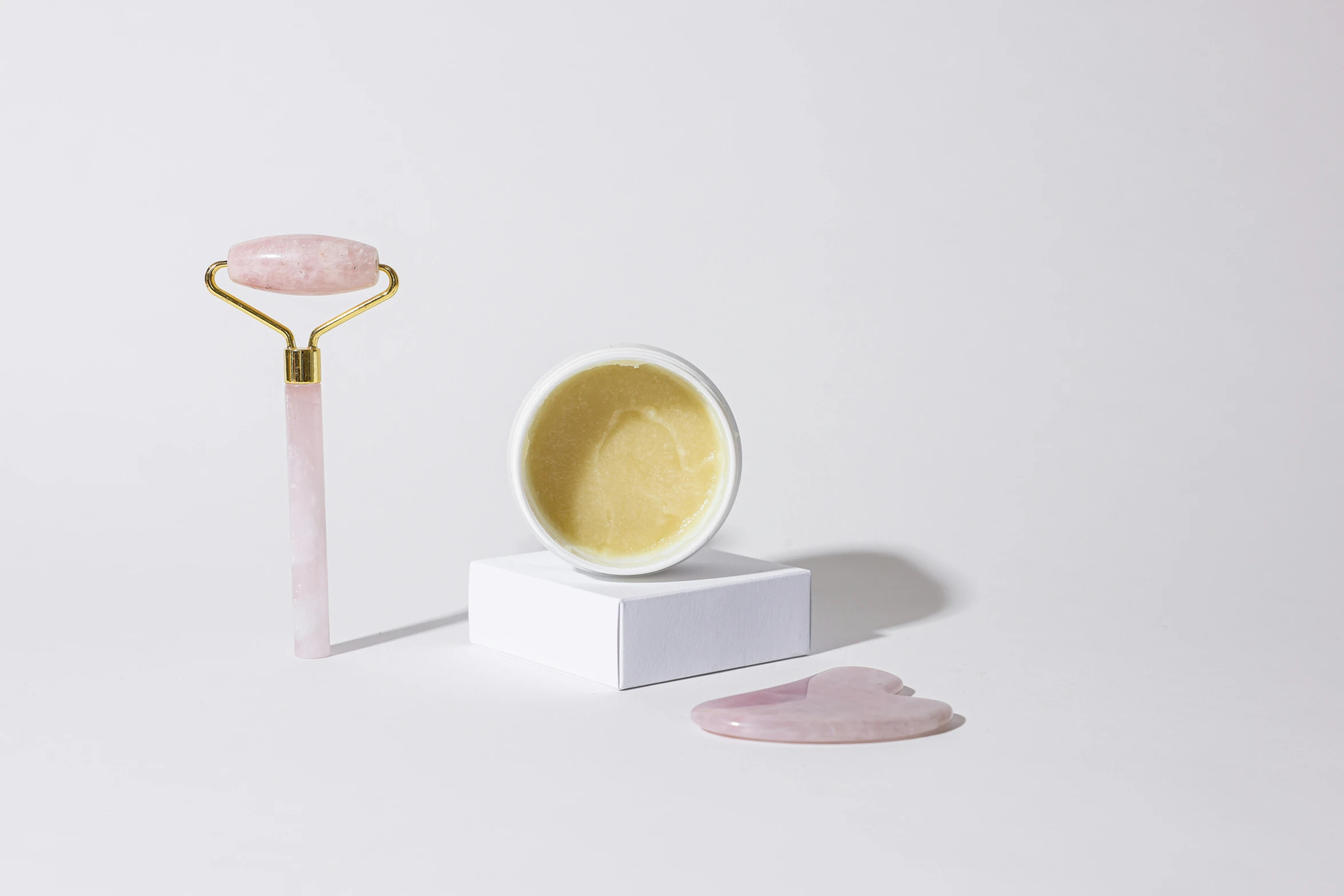 a close up of a pink object on a white surface, inspired by Évariste Vital Luminais, cream, golden mask, pestle, yellow aura