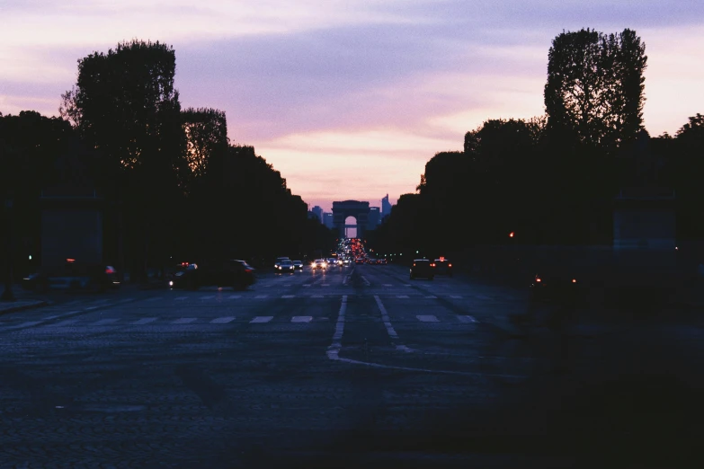 a street filled with lots of traffic next to tall buildings, an album cover, pexels contest winner, soft lilac skies, parisian street at night, 🚿🗝📝, overcast dawn