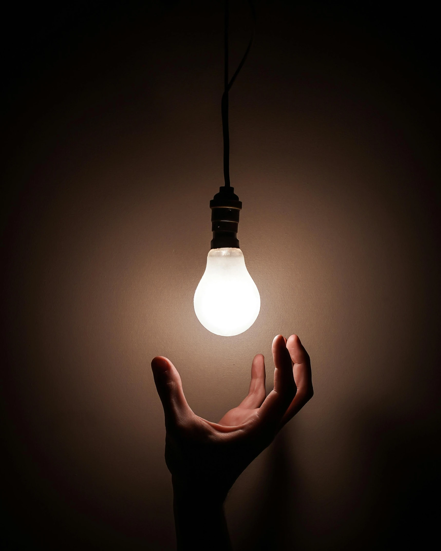 a person holding a light bulb in their hand, photo taken in 2018, advertising lighting, lights off, ilustration