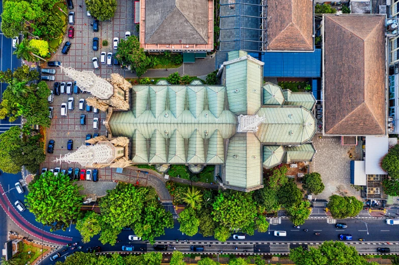 an aerial view of a large building surrounded by trees, by Daniel Lieske, pexels contest winner, art nouveau, south jakarta, cathedral, image split in half, street top view