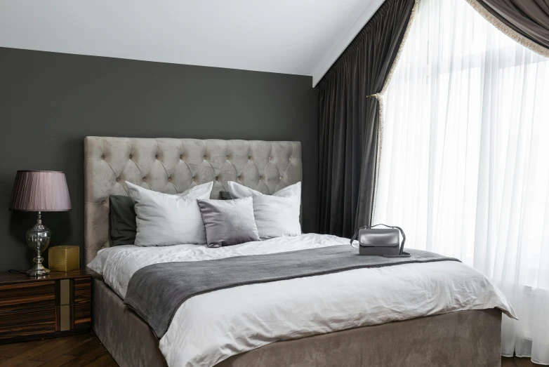 a bed sitting in a bedroom next to a window, inspired by Bedwyr Williams, unsplash, baroque, in gunmetal grey, white and silver, velvet tablecloth, plain background