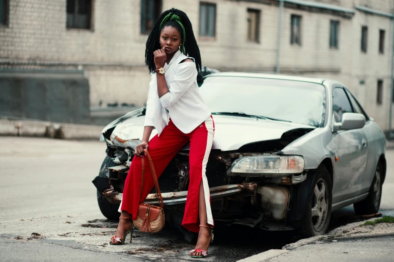 a woman sitting on the hood of a car talking on a cell phone, trending on pexels, auto-destructive art, a woman wearing red high heels, african woman, wearing off - white style, cars crashed