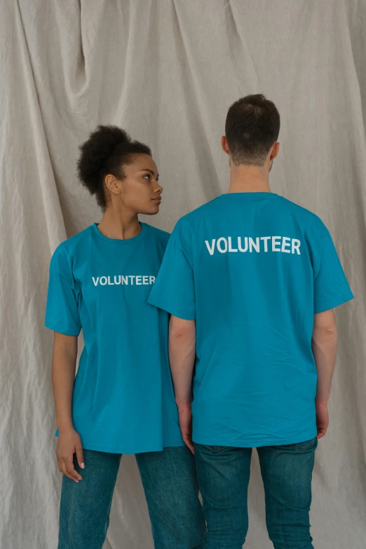 a couple of people standing next to each other, teal uniform, printed on a cream linen t-shirt, thumbnail, support