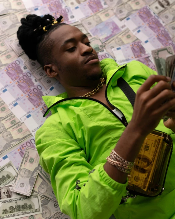 a man laying on top of a pile of money, an album cover, by Cosmo Alexander, trending on pexels, patron saint of 🛸🌈👩🏾, casually dressed, snapchat photo, glowy