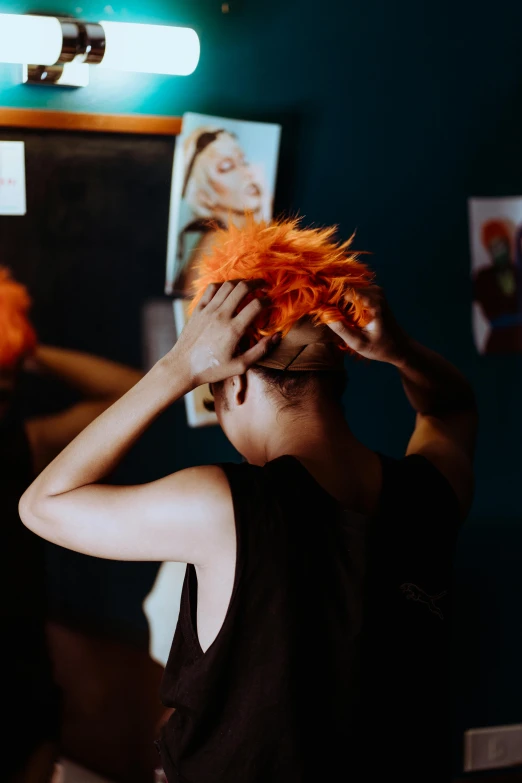 a woman with orange hair standing in front of a mirror, a cartoon, inspired by Nan Goldin, trending on pexels, mohawk haircut, paws on head, concert, complementary colour