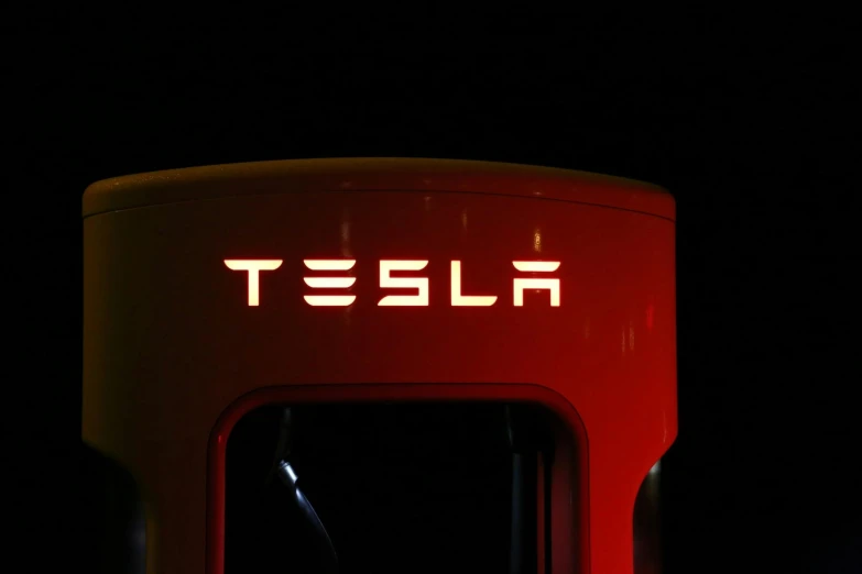 a tesla charging station lit up at night, trending on unsplash, white and red armor, vintage photo, engraved, leaked