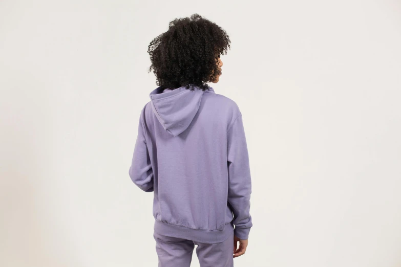 a woman standing in front of a white wall wearing a purple hoodie, facing away, product shot, muted colors. ue 5, ((purple))