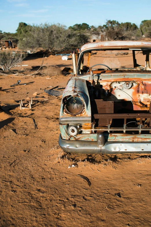 an old car that is sitting in the dirt, by Lee Loughridge, unsplash, auto-destructive art, square, outback, arizona, a high angle shot