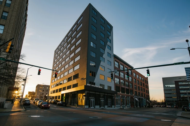 a tall building sitting on the side of a street, by Washington Allston, unsplash, bauhaus, evening light, cleveland, slide show, ignant