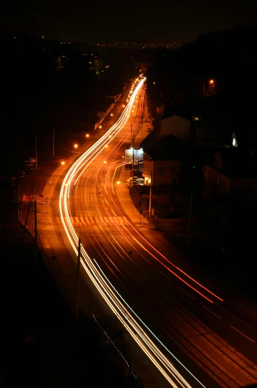a long exposure photo of a highway at night, flickr, overlooking a dark street, orange lights, karla ortiz, night time footage