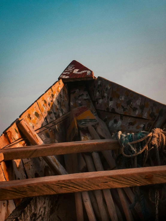 a wooden boat sitting on top of a sandy beach, an album cover, by Filip Hodas, unsplash contest winner, intricate detailed roof, profile image, ((rust)), islamic