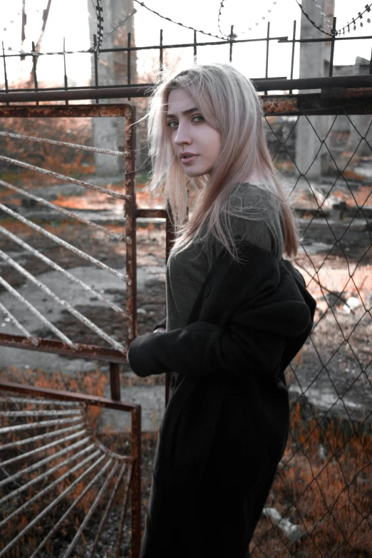 a woman standing in front of a fence, inspired by Elsa Bleda, realism, ( apocalyptic ) 8 k, pale hair, ((rust)), 🤤 girl portrait
