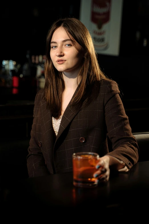 a woman sitting at a bar with a drink, a portrait, featured on reddit, wearing a worn out brown suit, 19-year-old girl, full res, jen atkin