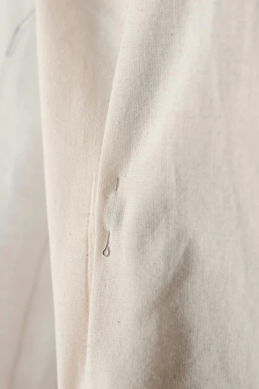 a close up of a shirt on a mannequin mannequin mannequin mannequin mannequin mannequin manne, inspired by Lucio Fontana, printed on a cream linen t-shirt, very long white cloak, curvilinear pencil marks, taken in the early 2020s