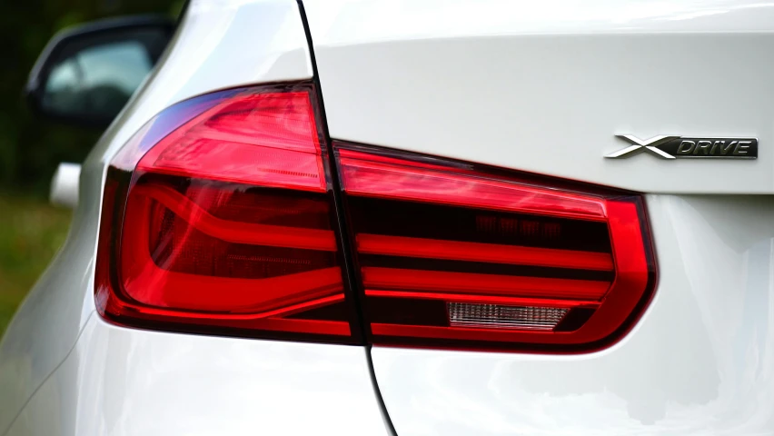 a close up of the tail lights of a white car, pexels contest winner, bmw, white and red body armor, side lighting xf iq4, rectangle