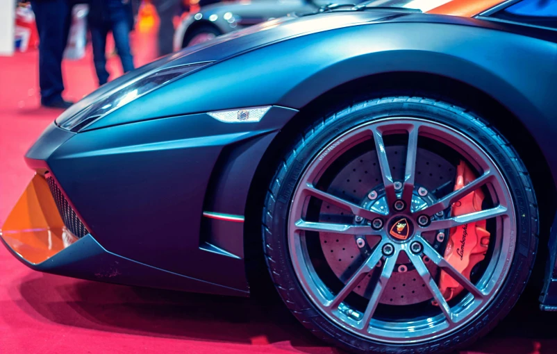 a close up of a car on a red carpet, pexels contest winner, photorealism, supercar, highly detailed wheels, thumbnail, black car