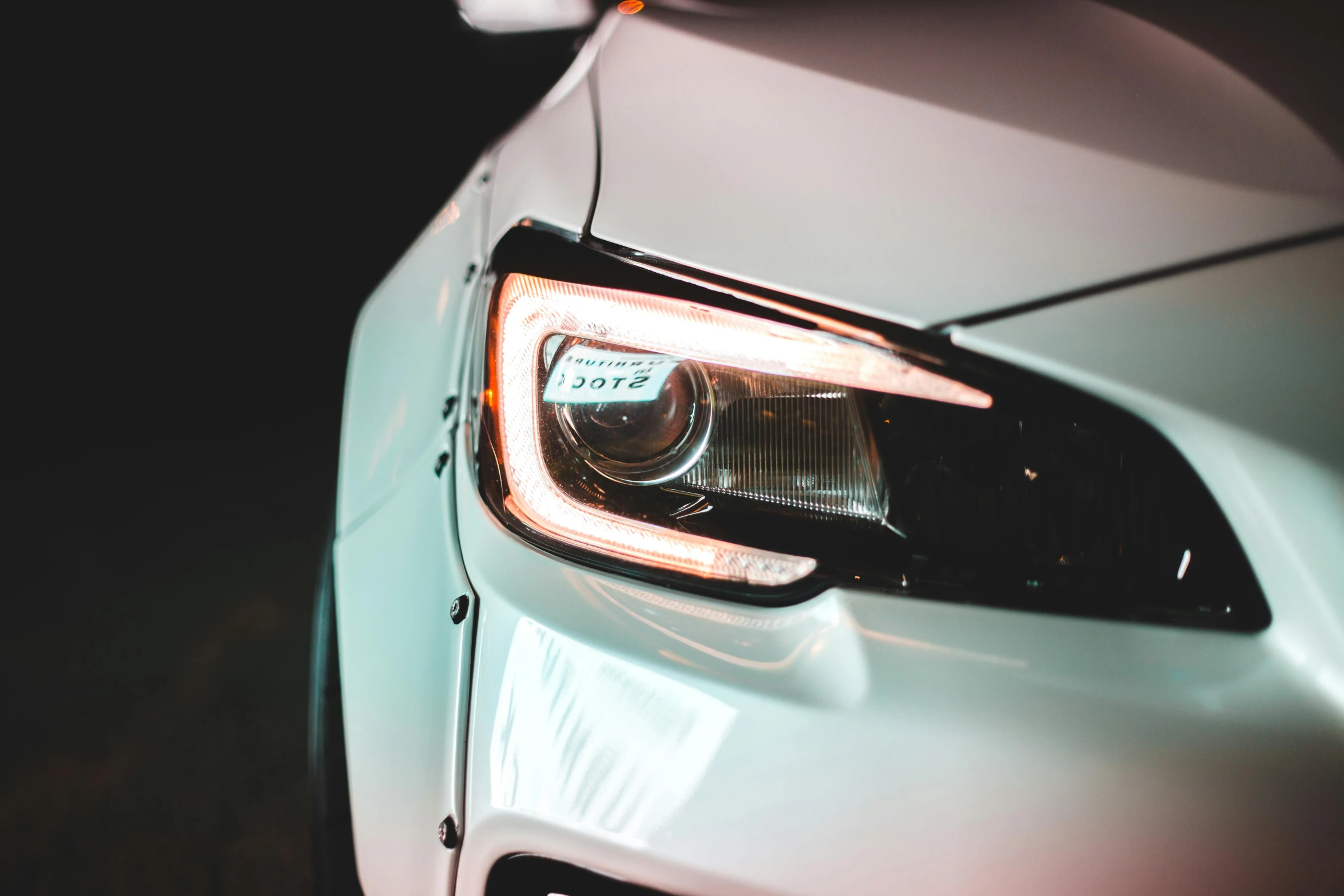 a close up of a headlight on a car, by Daniel Lieske, pexels contest winner, glossy white, avatar image, mid body shot, side lights