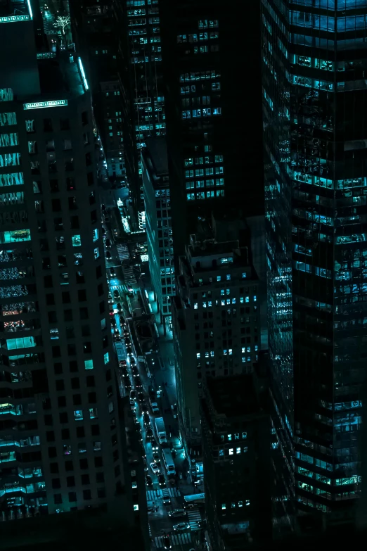 an aerial view of a city at night, inspired by Liam Wong, aquamarine windows, teal aesthetic, zoomed out shot, movie still from the matrix