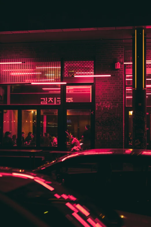 a couple of cars that are parked in front of a building, by Adam Marczyński, pexels contest winner, conceptual art, soft red lights, busy restaurant, red on black, pink