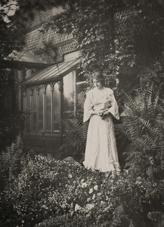 an old photo of a woman standing in a garden, a black and white photo, unsplash, pre-raphaelitism, greenhouse, holding her yorkshire terrier, fern, princess in foreground