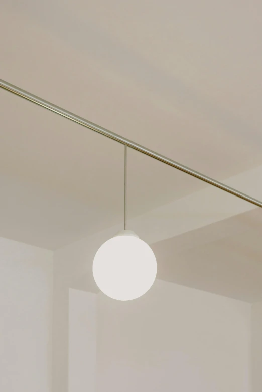 a bed room with a neatly made bed and a lamp, inspired by Cerith Wyn Evans, unsplash, bauhaus, glass ball, simple ceiling, cafe lighting, profile image