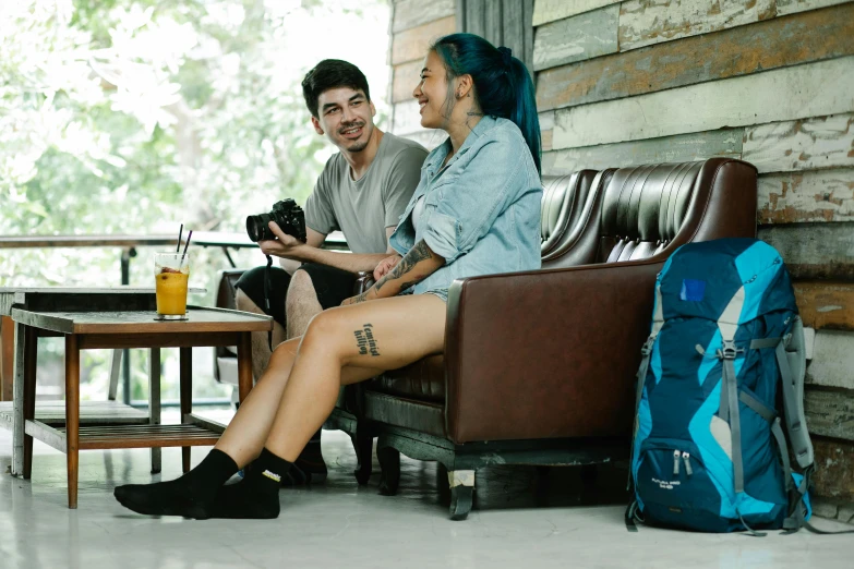 a couple of people that are sitting on a couch, pexels contest winner, a backpack, aussie baristas, avatar image, full length shot