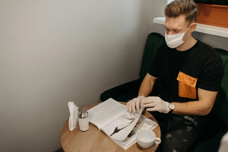 a man in a face mask sitting at a table, by Emma Andijewska, dentist, 4 0 9 6, lachlan bailey, hair detailing