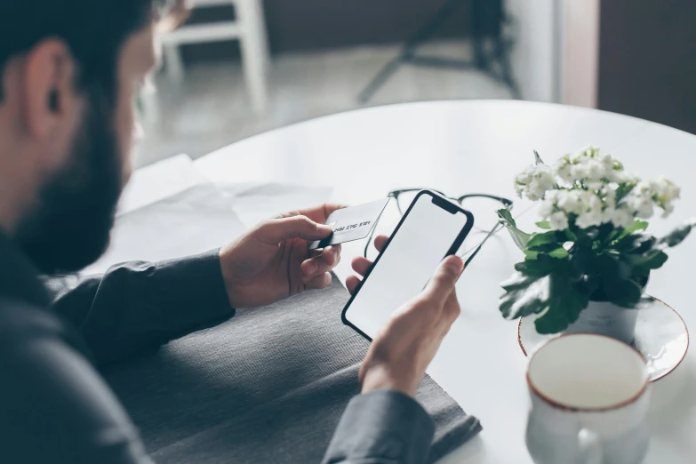 a man sitting at a table using a cell phone, pexels contest winner, clean and pristine design, avatar image, mid shot photo, professional profile picture