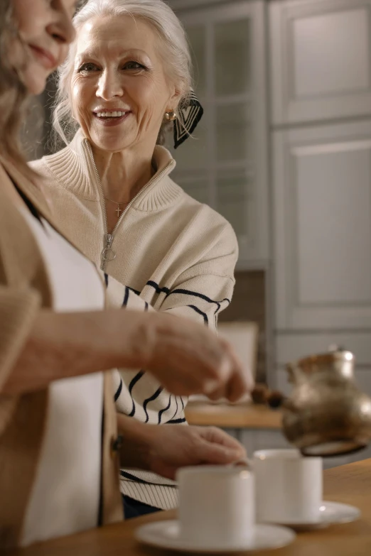 a couple of women standing next to each other in a kitchen, trending on pexels, renaissance, calmly conversing 8k, smiling woman, pouring, abundent in details