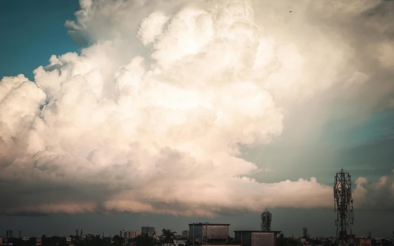 a large cloud is in the sky over a city, by Adam Marczyński, thunderclouds, filling the frame, multiple stories, portrait photo
