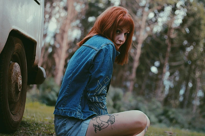 a woman sitting on the ground next to a truck, a photo, inspired by Elsa Bleda, tumblr, graffiti, cute young redhead girl, chloe price from life is strange, photograph of a sleeve tattoo, photo pinterest