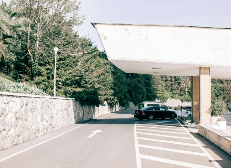 a car is parked on the side of the road, unsplash, brutalism, in karuizawa, italy, pov photo, entrance