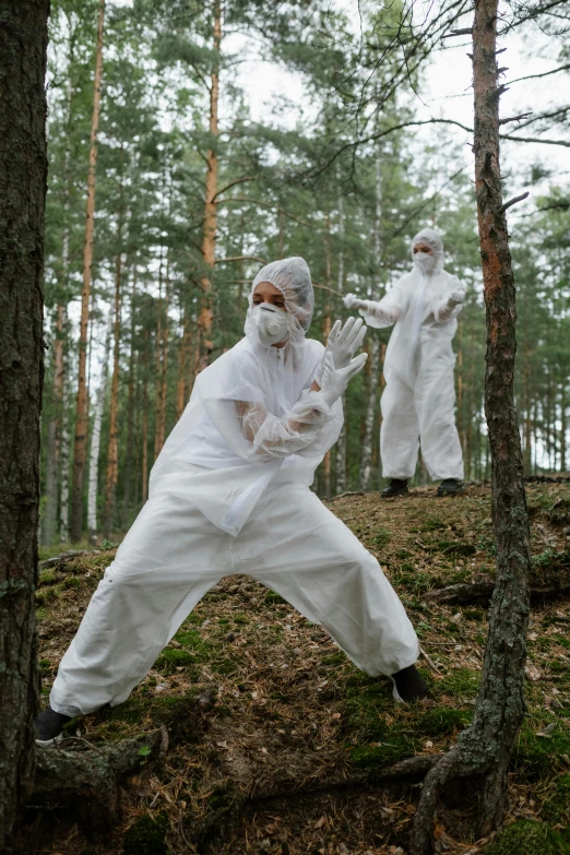 a couple of people that are in the woods, by Marina Abramović, unsplash, environmental art, karate outfit, russian lab experiment, costumes, labcoats