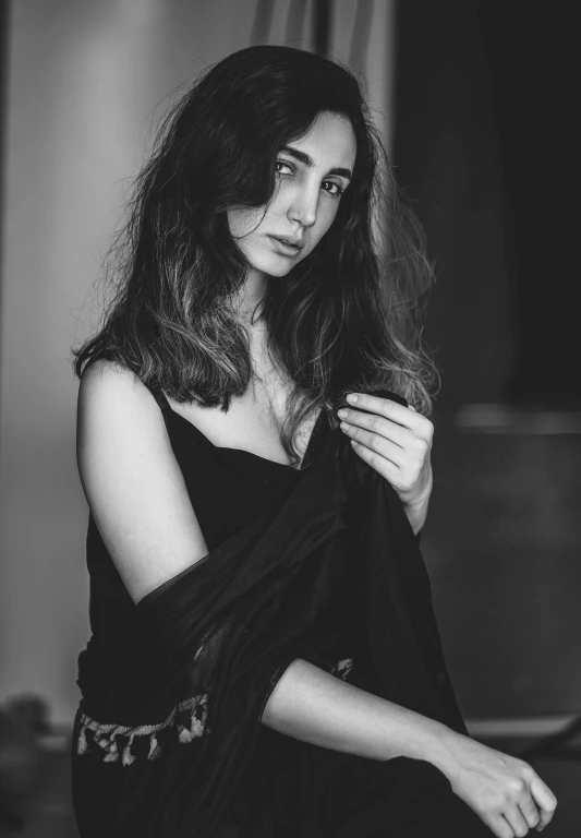 a black and white photo of a woman in a black dress, a black and white photo, inspired by irakli nadar, pexels contest winner, photorealism, lilly collins, medium format. soft light, mahira khan as a mage, wearing a camisole