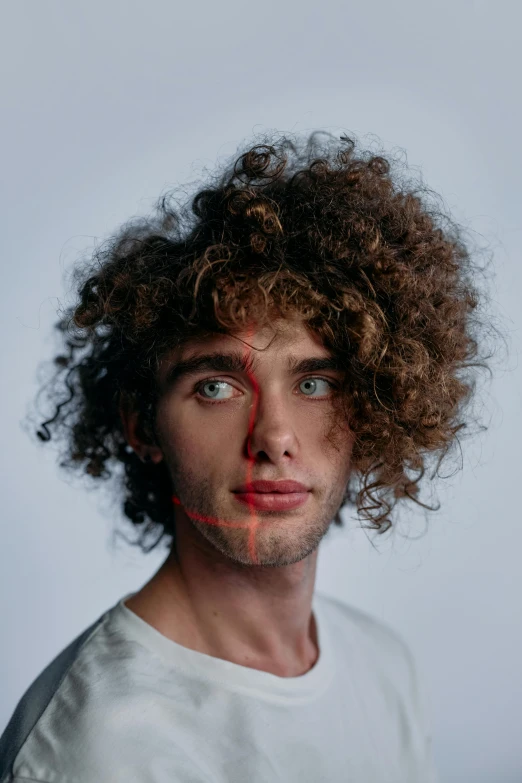 a man with red paint on his face, an album cover, trending on pexels, curly middle part haircut, adam ondra, who is a male android, postprocessed