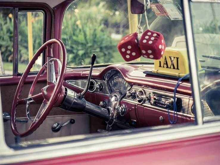 a close up of a steering wheel and dashboard of a car, a colorized photo, by Joe Bowler, pexels contest winner, taxi, square, crimson themed, polka dot