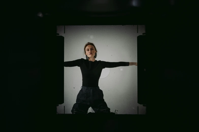 a woman standing in front of a white screen, a hologram, inspired by Anna Füssli, unsplash, arms extended, shot with hasselblad, androgynous person, greta thunberg