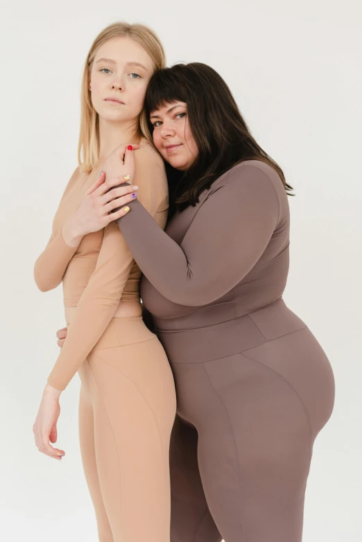 a couple of women standing next to each other, inspired by Vanessa Beecroft, trending on pexels, renaissance, in spandex suit, obese ), taupe, full product shot