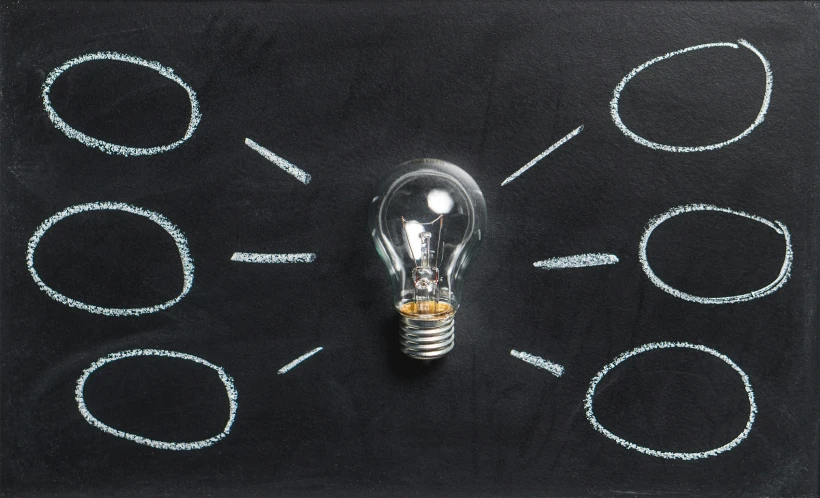 a light bulb sitting on top of a blackboard, listing image, birdseye view, multiple lights, product lighting