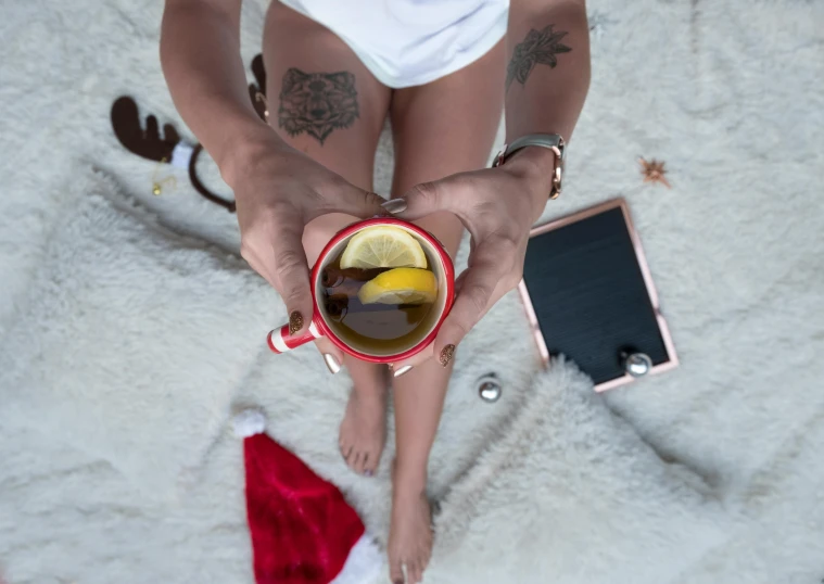 a woman in a santa hat holding a cup of tea, pexels, exposed thighs, flatlay, avatar image, tans