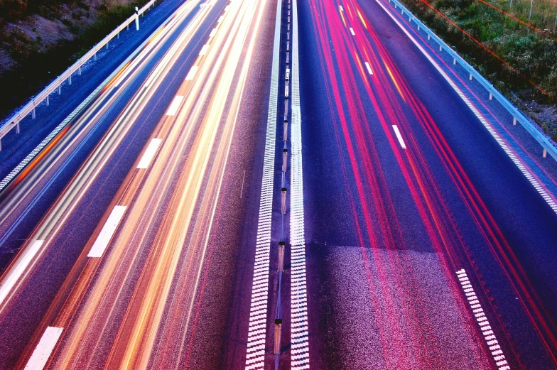 a highway filled with lots of traffic next to a forest, an album cover, unsplash, incoherents, purple and pink and blue neons, vertical lines, infrastructure, instagram post