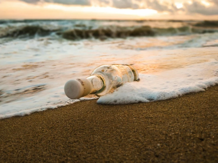 a bottle sitting on top of a beach next to the ocean, pexels contest winner, renaissance, sinking as if drowing, white, vapourwave, profile image