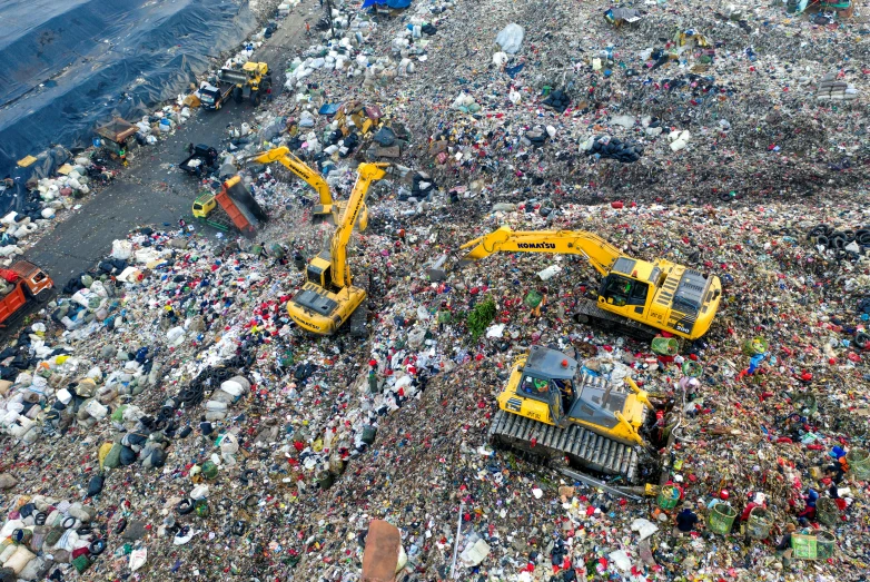 a large pile of garbage next to a body of water, massive construction machines, image credit nasa nat geo, 💋 💄 👠 👗, dezeen