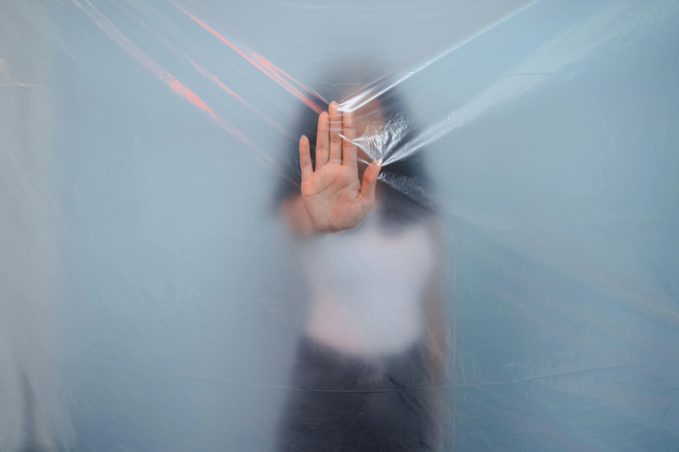 a blurry image of a person holding an umbrella, a hologram, inspired by Anna Füssli, unsplash, interactive art, bandage taped fists, soft translucent fabric folds, plain background, silk tarps hanging