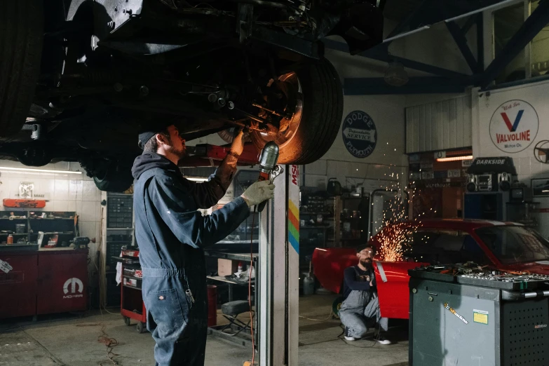 a man working on a car in a garage, pexels contest winner, heartbreak, avatar image, plating, full colour